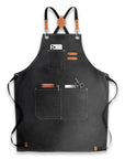 Black canvas apron with leather straps and pockets.