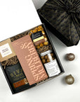 Gift box with Rival Bros coffee, Spring & Mulberry chocolate, and other snacks on a white background