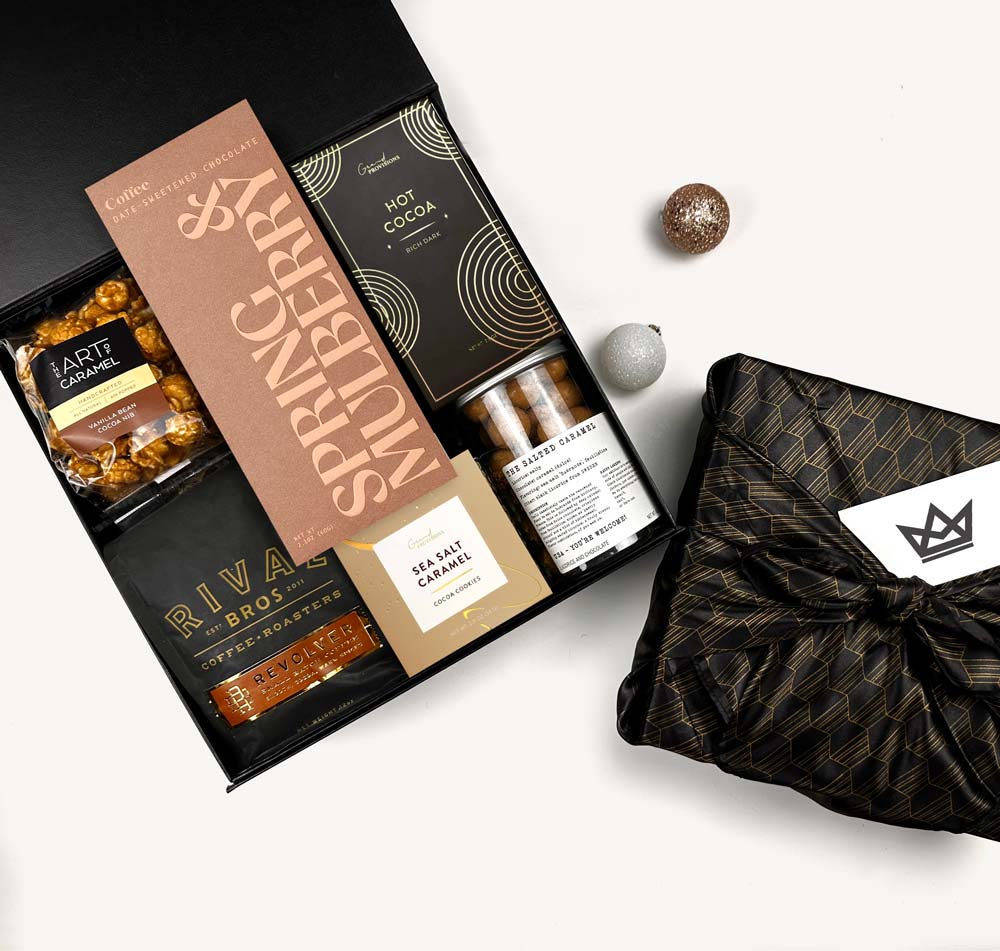 Gift box with Springberry Mulled Cider and Riva Bros products on a white background