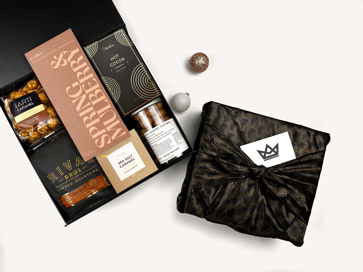 Gourmet chocolate assortment with branded packaging on a white background