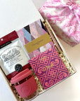 kadoo desk essential for her gift box. Gift items: christian lacroix notebook, chocolate, sol cup, cookie and more. wrapped in pink furoshiki fabric.