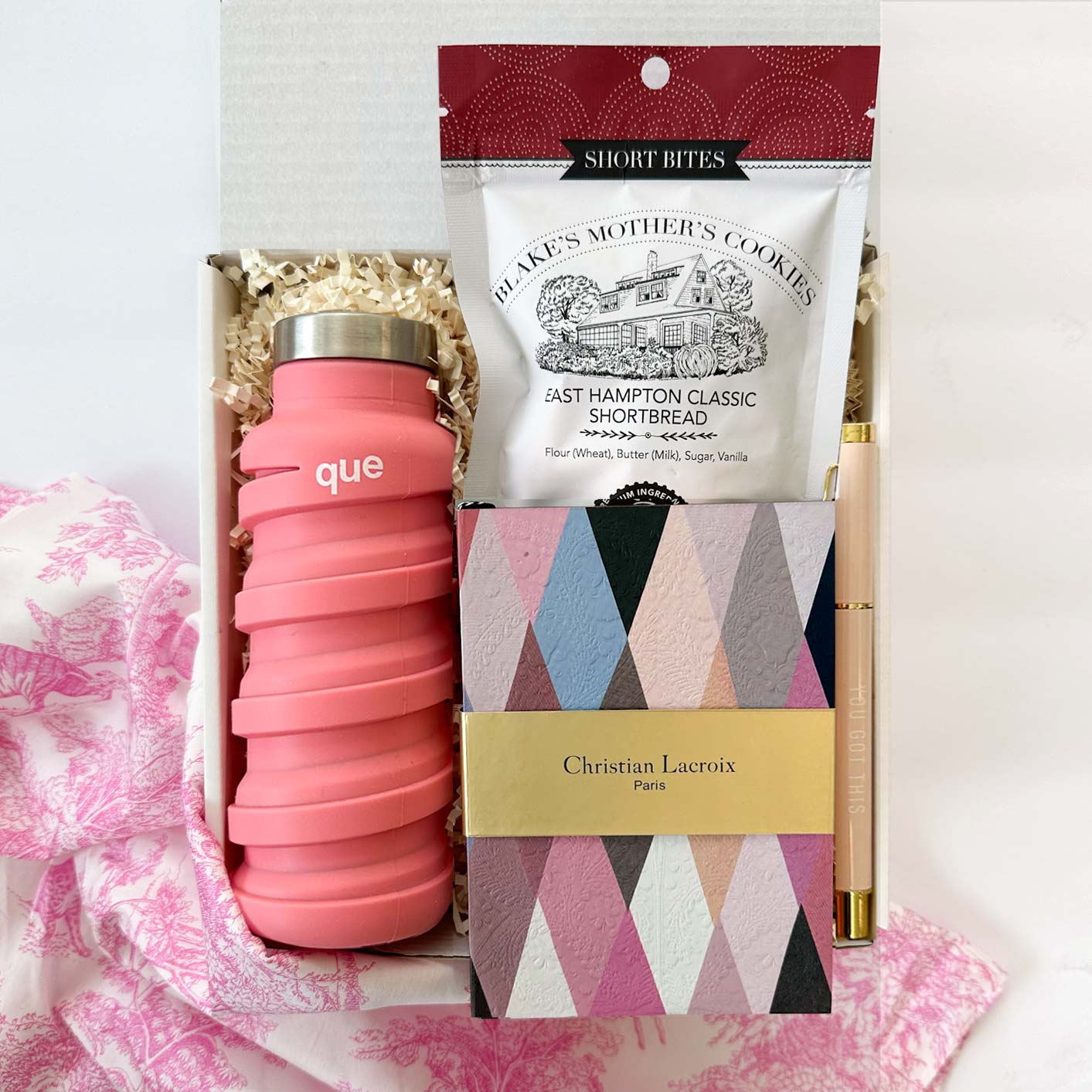 kadoo desk essential for her gift box. Gift items: christian lacroix notebook, que pink bottle, cookie and more.