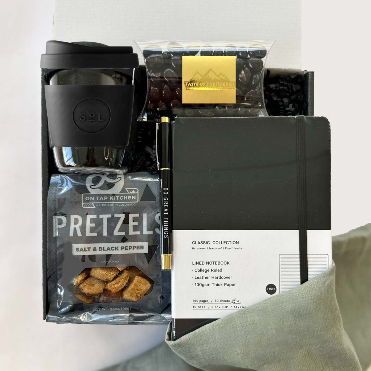 kadoo do great things gift box with black sol cup, pretzel, black notebook, pen, espresso beans candy and more