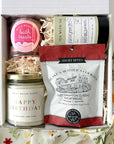 kadoo birthday celebration gift box with happy birthday candle, champagne sugar bath treats, jasmine green tea, shortbread & more.