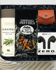 tech lover - gadget desk gift for him with compact wireless earbuds, airpod leather case, sweet treats & more.