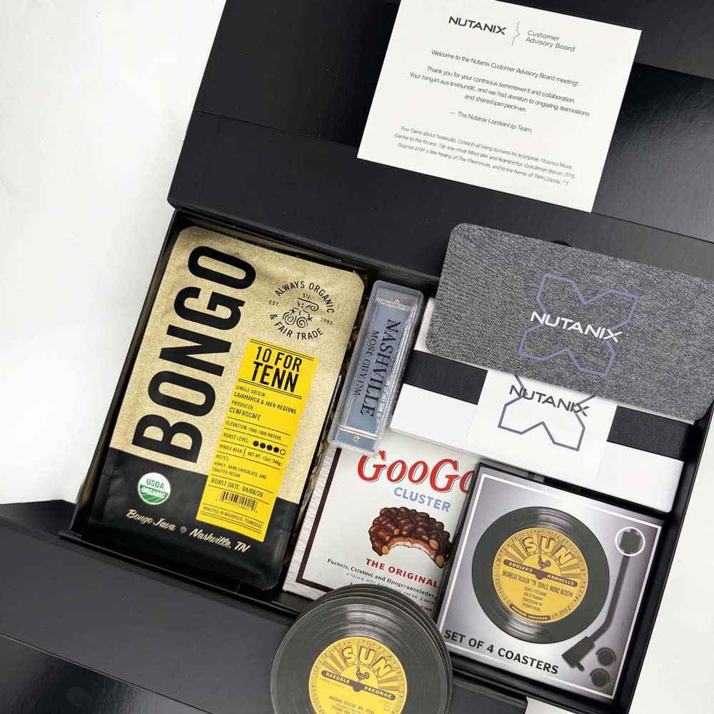 Collection of branded items including a Bongo snack bag, Nutanix coasters, and FUBU record-style coaster set in a box.