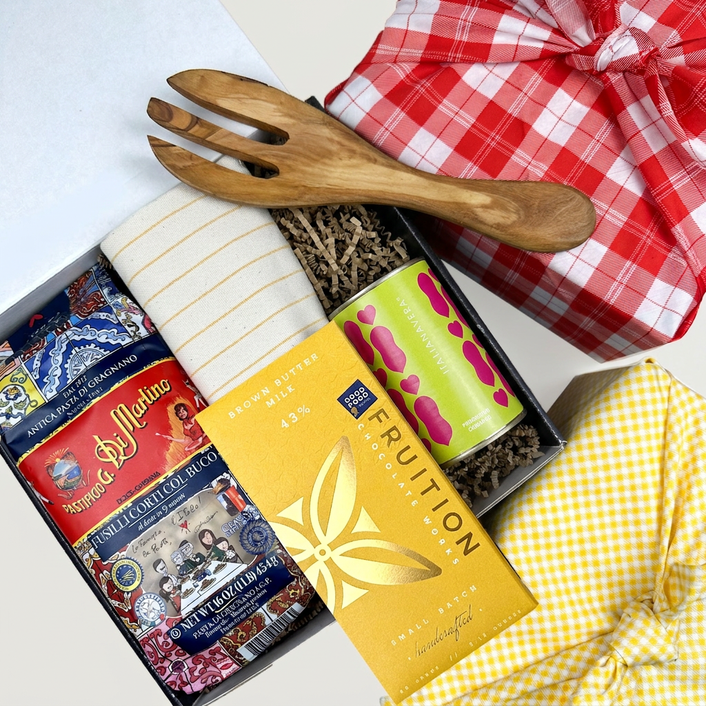 Kadoo gift set with a wooden fork, pasta, sauce, chocolate, and tea towel with furoshiki wrapping.