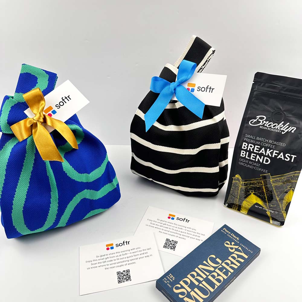 Three gift bags with ribbons and a coffee package on a light gray background