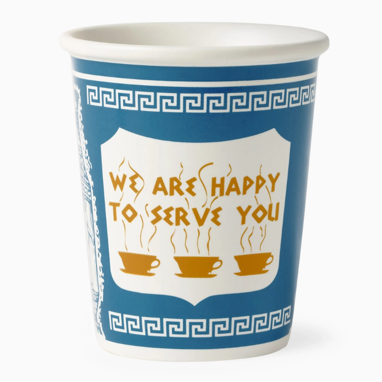 A white ceramic coffee cup with a blue and white Greek key pattern and a central white shield containing the text 'WE ARE HAPPY TO SERVE YOU' in gold, above illustration of three gold coffee cups.