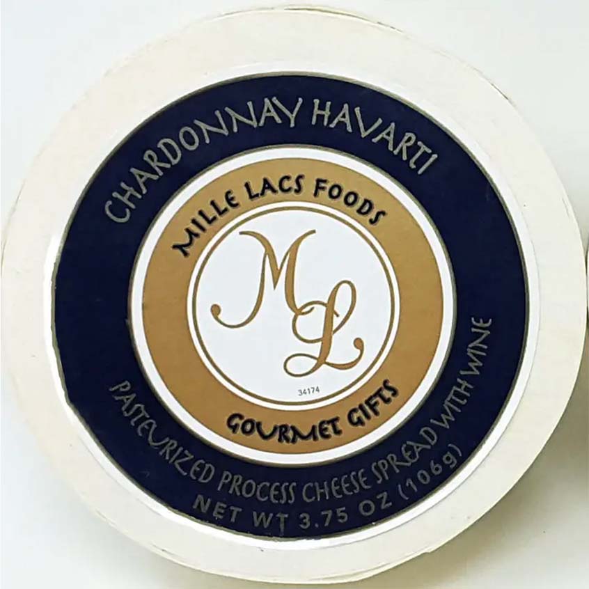 A round cheese spread package lid or top label for Mille Lacs Foods Chardonnay Havarti, with a cream outer ring, dark navy blue band, and tan center featuring the stylized 'ML' logo and product text.