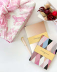 Christian Lacroix Paris Notebook with pen, dry flower bouquet, pink furoshiki fabric wrapped gift box and more