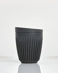 Charcoal colored Huskee cup with lid on a white background