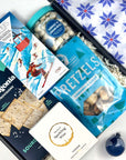 kadoo après ski holiday curated gift box with patagonia crackers, vinoos wine gummies, compartes hot cocoa chocolate bar, pretzels, candy club cookies cream bites and more