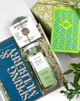 Kadoo gift set with chocolate, soap, perfume, and a card on a white background
