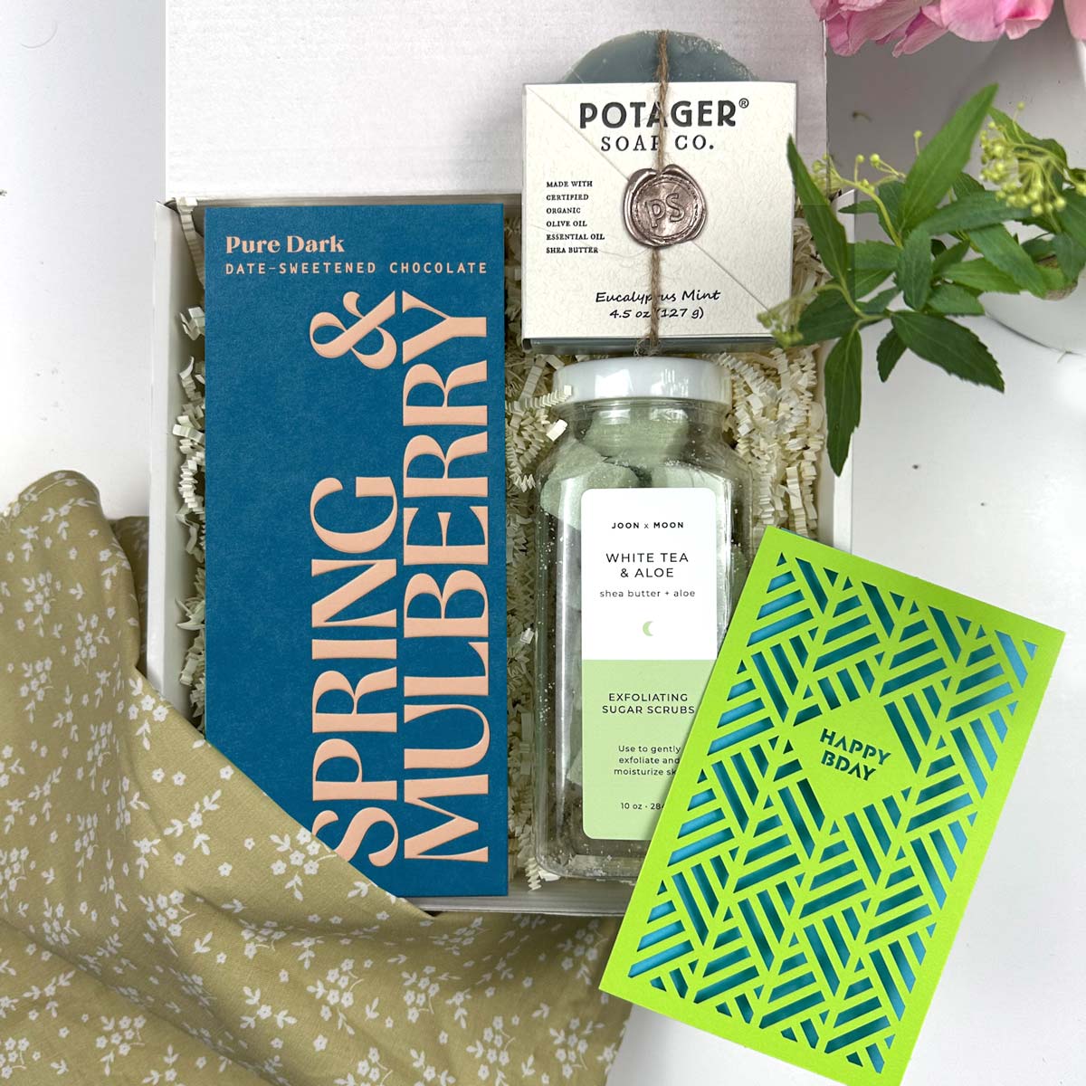 Kadoo Gift set with Spring & Mulberry chocolate, Potager soap, and a card on a white surface.