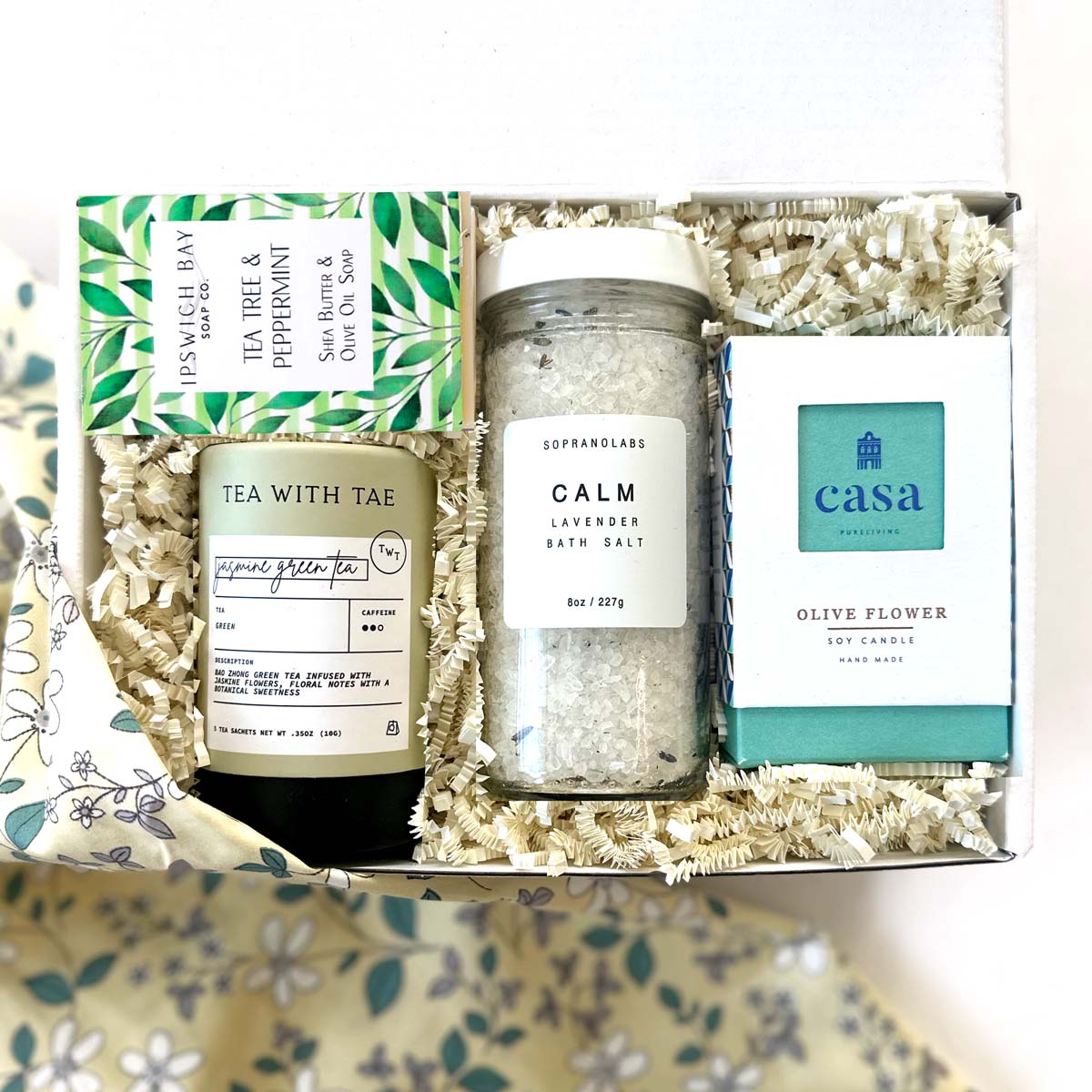 kadoo calm spa curated gift box. gifts included lavender bath salt, olive flower soy candle, tea tree peppermint soap, jasmine tea and more