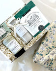 kadoo calm spa curated gift box wrapped in reusable furoshiki fabric wrap. gifts included lavender bath salt, rosemary shortbread, jasmine soap, jasmine tea and more