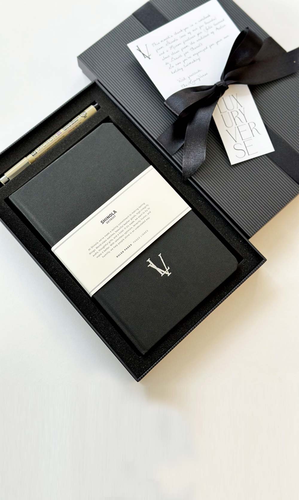 branded notebook with logo on black shinola notebook and micro pen, in black ribbon gift box