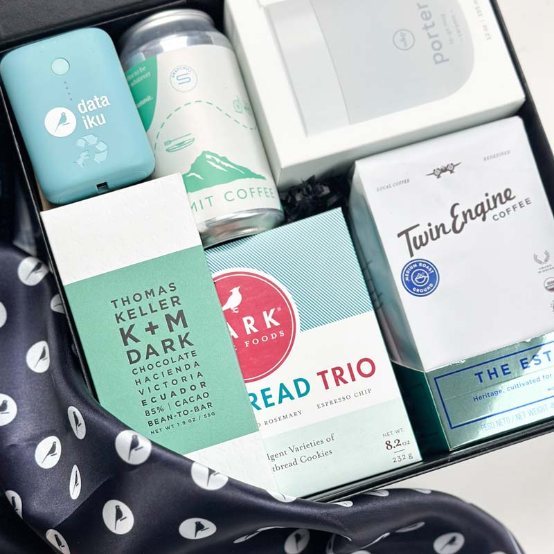 Custom corporate gift box for Dataiku Advisory Board. Gifts included: chocolater bar, cookie, twin engine coffee, branded portable charger, mug, summit coffee and more