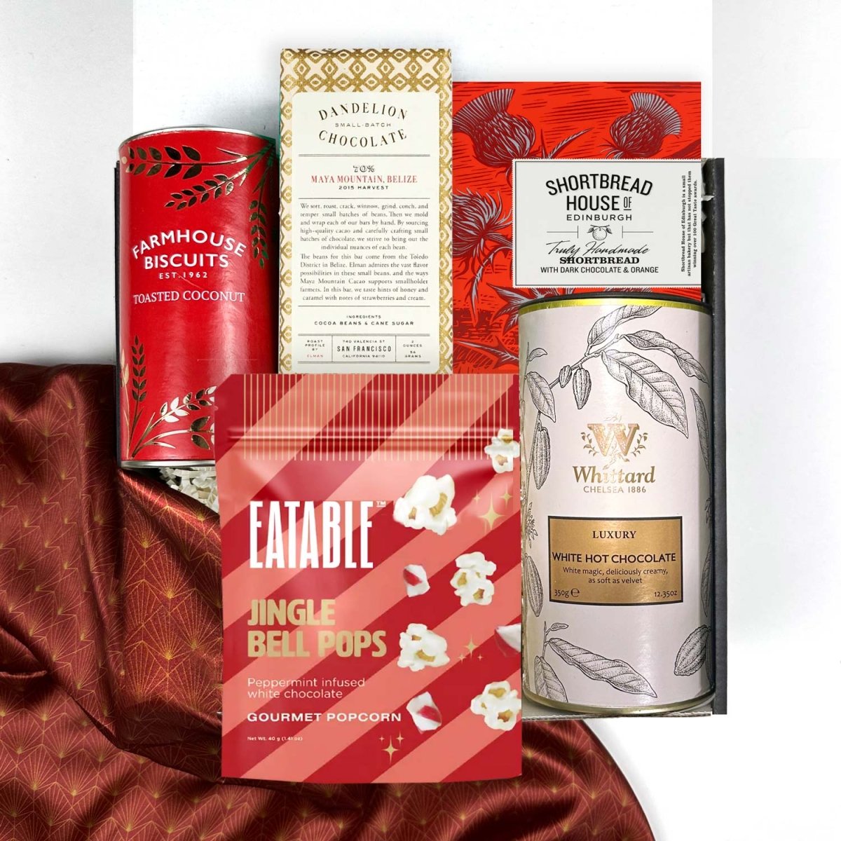 kadoo festive holiday curated gift box filled with jingle bells pops popcorn, whittard luxury white hot chocolate, dandelion chocolate, shortbread, biscuits and more