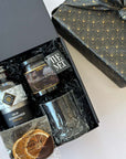 kadoo old fashioned curated gift box with cocktail syrup, The MET jam, viski crystal tumbler, orange slice and more. Wrapped in black reusable furoshiki fabric wrap. 