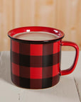 Red and black checkered mug with a handle on a wooden surface