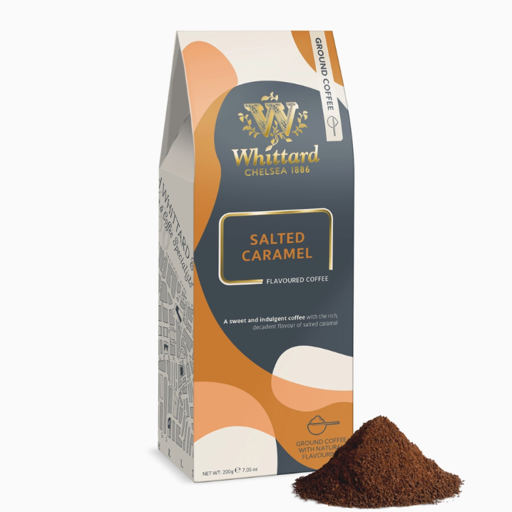 A package of Whittard of Chelsea 1886 Salted Caramel Flavoured Coffee, shown standing upright with a small pile of ground coffee in front on a white background.