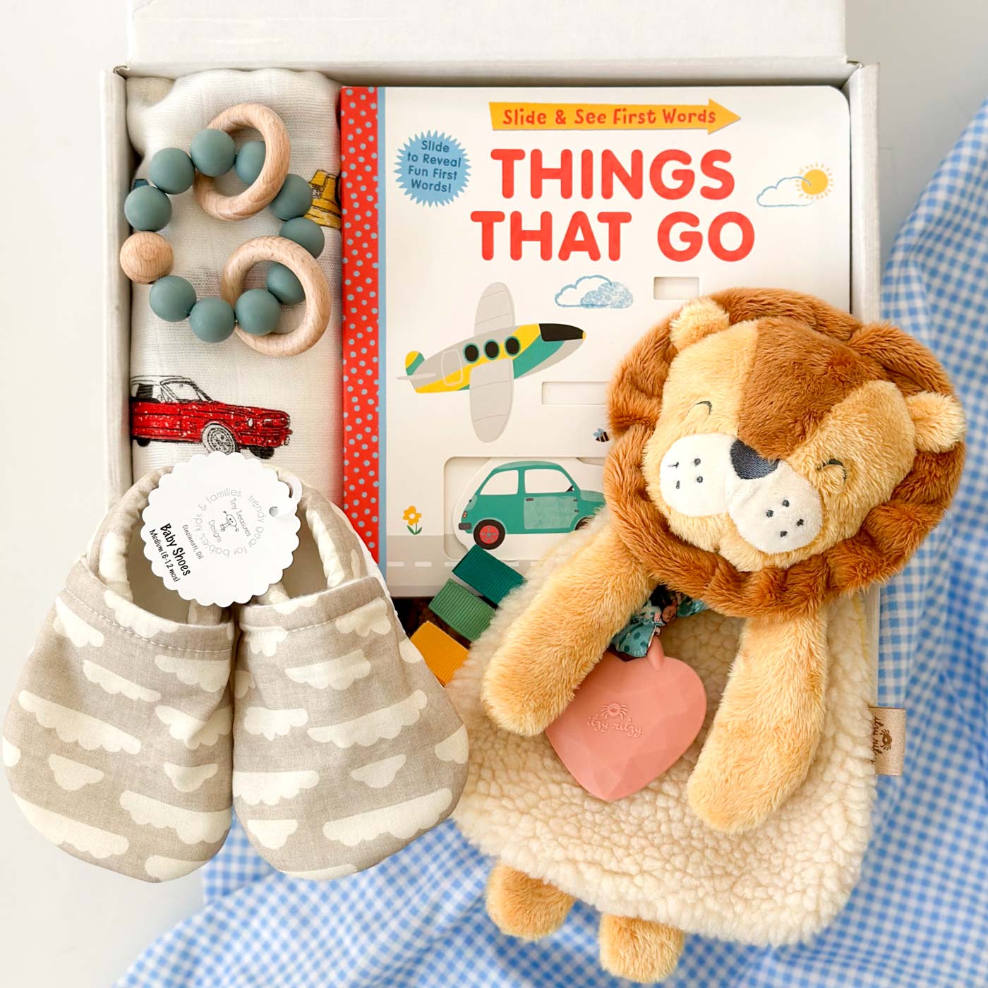 kadoo baby boy gifts things that go, include board book, lion plush, baby shoes, swaddle, teether & more.