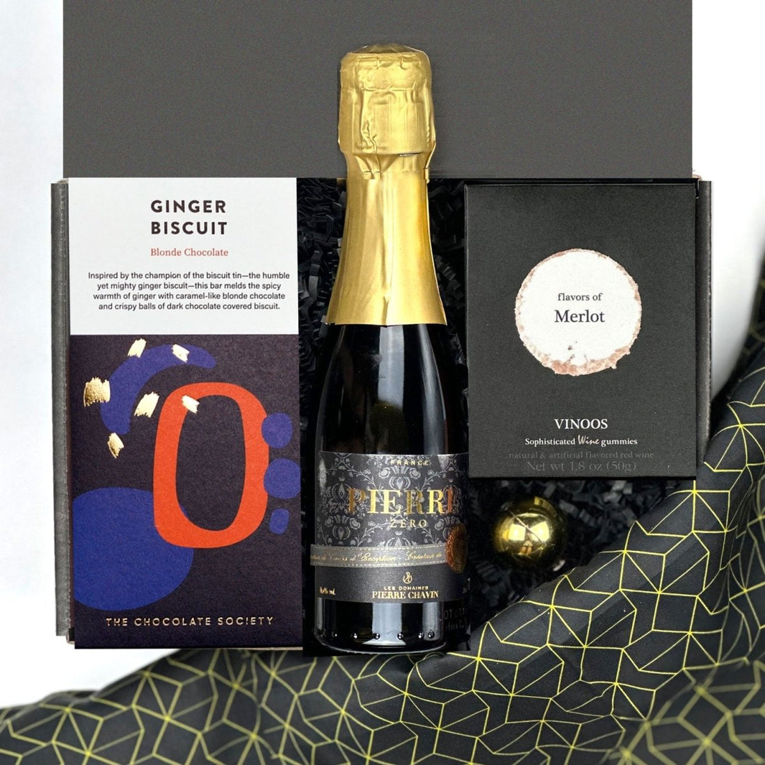 kadoo celebration holiday curated gift box filled with pierre zero-alcohol sparkling wine, ginger biscuit chocolate, merlot wine gummies & more.