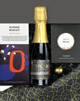 kadoo celebration holiday curated gift box filled with pierre zero-alcohol sparkling wine, ginger biscuit chocolate, merlot wine gummies & more.