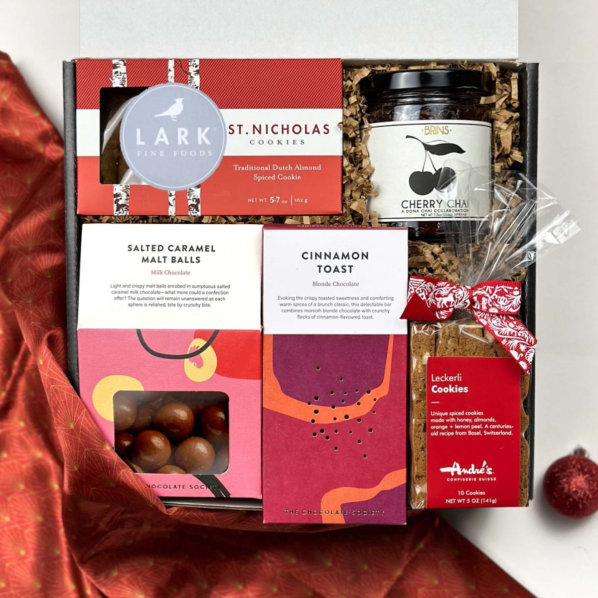 kadoo holiday cheers gift box with chocolate, cookies, jam, and more. Wrapped in reusable Furoshiki fabric.