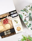 kadoo holiday cheese gift box with eco-friendly furoshiki fabric wrap. Gifts: cheese, cracker, chocolate, salami, jam & more.