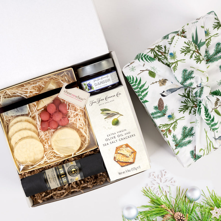 kadoo holiday cheese gift box with eco-friendly furoshiki fabric wrap. Gifts: cheese, cracker, chocolate, salami, jam & more.