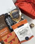 kadoo gourmet pancake holiday gift box wrapped in furoshiki fabric, with pancake & waffle mix, cinnamon maple syrup, apple pie chocolate, cookie and more