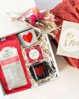 kadoo mr and mrs. wedding curated gift box in furoshiki fabric wrap, with coffee, two heart espresso cups, sugarfina gummy bears & more.