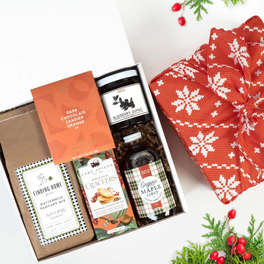 pancake curated gift box with buttermilk pancake mix, orange dark chocolate, crackers, jam, & maple syrup.