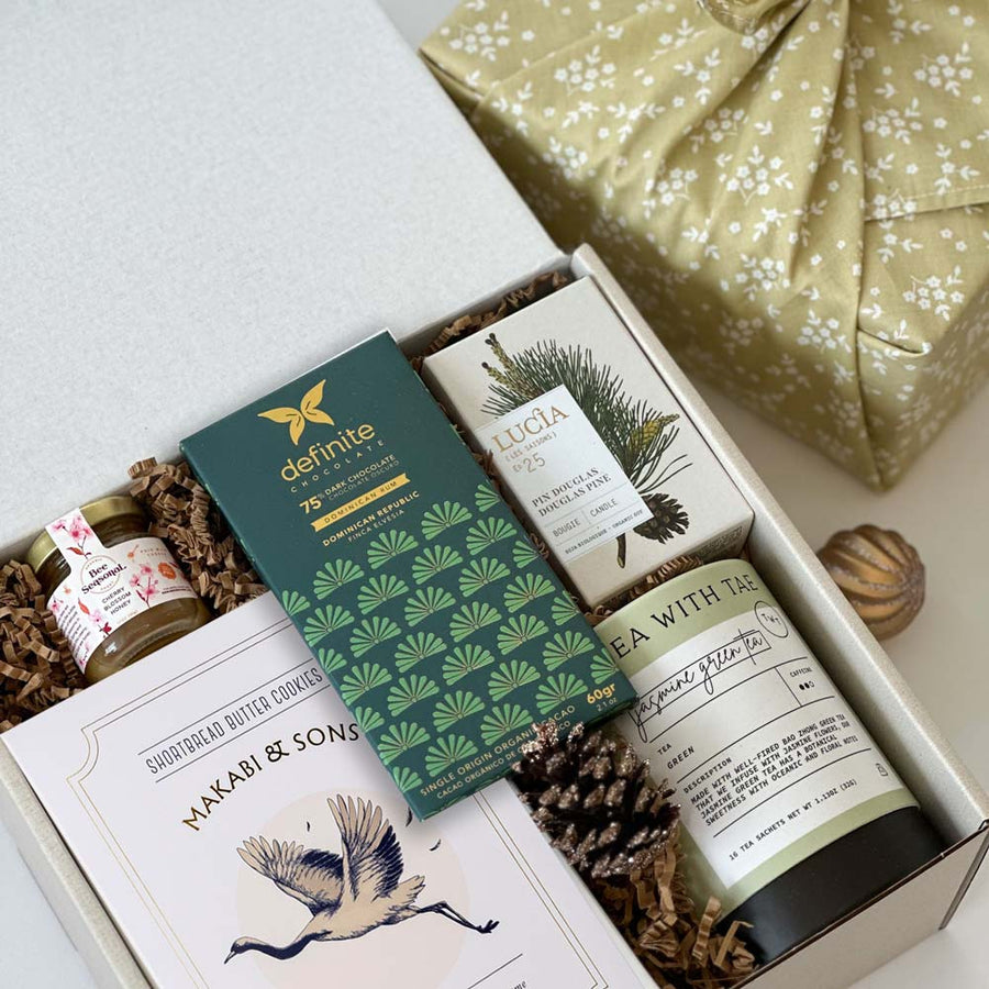 kadoo holiday gift box with tea, cookie, honey, chocolate, candle and more, in reusable furoshiki fabric wrap