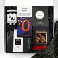 kadoo winter spice holiday curated gift box. Packed with sweet and savory winter treats: hot chocolate, chocolate bar, merlot wine gums, jam, artisan nuts and more.